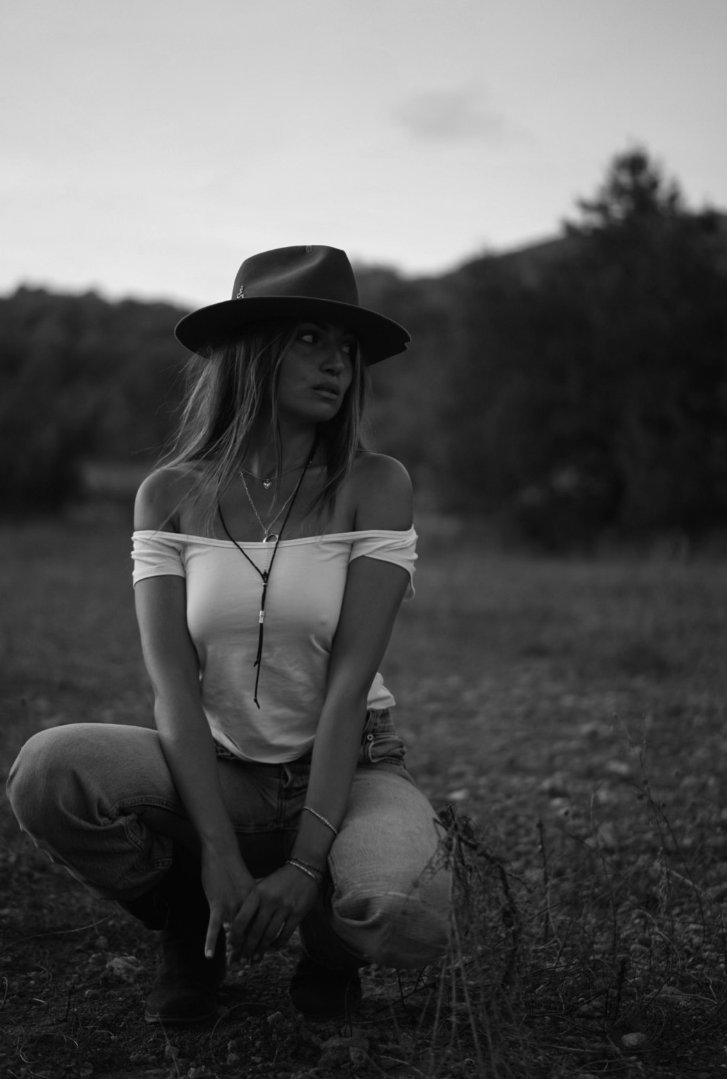 Talia Elbaz, Spiritual Mentor, in a wide-brimmed hat in an open field